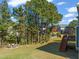 Spacious backyard with deck, fire pit, and mature trees at 454 Big Willow Way, Rolesville, NC 27571