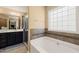 Relaxing bathroom features soaking tub, double vanity, and shower at 454 Big Willow Way, Rolesville, NC 27571