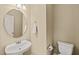 Powder room with pedestal sink, oval mirror, and toilet at 454 Big Willow Way, Rolesville, NC 27571