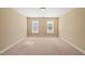 Well-lit bedroom with two windows and neutral decor at 454 Big Willow Way, Rolesville, NC 27571