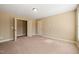 Bright bedroom featuring two entry doors and carpet flooring at 454 Big Willow Way, Rolesville, NC 27571
