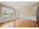 Bright dining room with hardwood floors, crown molding, and large window at 454 Big Willow Way, Rolesville, NC 27571