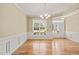 Bright dining room with hardwood floors, crown molding, and large window at 454 Big Willow Way, Rolesville, NC 27571