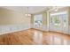 Bright dining room with hardwood floors, crown molding, and large window at 454 Big Willow Way, Rolesville, NC 27571