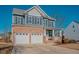Two-story home with brick and siding exterior, two-car garage, and front porch at 454 Big Willow Way, Rolesville, NC 27571