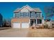 Two-story home with brick and siding exterior, two-car garage, and front porch at 454 Big Willow Way, Rolesville, NC 27571