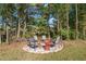 Cozy fire pit seating area in a wooded backyard setting at 454 Big Willow Way, Rolesville, NC 27571