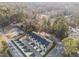 An aerial view shows newly constructed townhomes in a wooded suburban setting with street access and parking at 811 Maple Berry Ln # 101, Raleigh, NC 27607