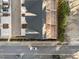 An aerial view showcases rooftop decks of townhomes along quiet streets, surrounded by mature trees and parking at 811 Maple Berry Ln # 101, Raleigh, NC 27607