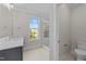 Bright bathroom featuring a glass shower, modern vanity, and a window offering natural light at 811 Maple Berry Ln # 101, Raleigh, NC 27607