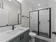 Modern bathroom featuring a glass enclosed shower, black hardware, stylish vanity and sleek, contemporary finishes at 811 Maple Berry Ln # 101, Raleigh, NC 27607