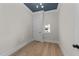 Neutral bedroom with a small window, light hardwood floors and a dark blue ceiling at 811 Maple Berry Ln # 101, Raleigh, NC 27607