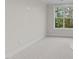 Minimalist bedroom featuring light walls, soft carpet, and a window providing ample natural light at 811 Maple Berry Ln # 101, Raleigh, NC 27607