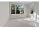 Well-lit bedroom with soft carpeting, large windows, and neutral walls at 811 Maple Berry Ln # 101, Raleigh, NC 27607