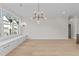 Spacious and bright dining area with large windows, hardwood floors, elegant lighting, and modern design at 811 Maple Berry Ln # 101, Raleigh, NC 27607