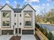 Modern townhome showcasing black-trimmed windows, dark garage doors, and a well-kept front yard at 811 Maple Berry Ln # 101, Raleigh, NC 27607