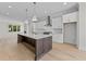 Spacious kitchen with a large center island, modern appliances, and a seamless flow into the adjacent living space at 811 Maple Berry Ln # 101, Raleigh, NC 27607