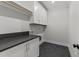 Well-lit laundry room with a dark countertop and modern cabinetry at 811 Maple Berry Ln # 101, Raleigh, NC 27607