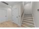 Stairway with wood treads and white risers next to white walls, doors, and a storage closet at 811 Maple Berry Ln # 101, Raleigh, NC 27607