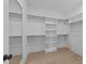 Bright walk-in closet with custom shelving and hardwood floors at 811 Maple Berry Ln # 101, Raleigh, NC 27607