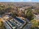 An aerial view of newly built townhomes, showcasing a modern design within a wooded suburban setting at 811 Maple Berry Ln # 102, Raleigh, NC 27607