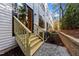 Exterior view of a backyard with a wooden staircase and patio area at 811 Maple Berry Ln # 102, Raleigh, NC 27607