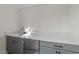 Wet bar features grey cabinets, modern hardware, a sink, and white countertop at 811 Maple Berry Ln # 102, Raleigh, NC 27607