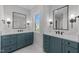 Bathroom featuring double vanities with modern cabinetry and quartz countertop at 811 Maple Berry Ln # 102, Raleigh, NC 27607
