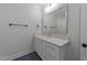 Bright bathroom featuring white vanity with white countertop, updated hardware, and a large mirror at 811 Maple Berry Ln # 102, Raleigh, NC 27607