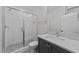 Bright bathroom with glass-enclosed shower, grey tile floors, and a modern white vanity at 811 Maple Berry Ln # 102, Raleigh, NC 27607