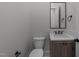 Charming powder room featuring a dark wood vanity, stone countertop, and matte black fixtures at 811 Maple Berry Ln # 102, Raleigh, NC 27607