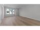 Bright bedroom featuring hardwood floors and a large window at 811 Maple Berry Ln # 102, Raleigh, NC 27607