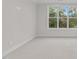 Carpeted bedroom with large window offering views of trees, allowing for plenty of natural light at 811 Maple Berry Ln # 102, Raleigh, NC 27607