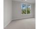 Neutral bedroom offering a large window with a view of mature trees and comfortable carpeting at 811 Maple Berry Ln # 102, Raleigh, NC 27607