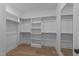 Spacious walk-in closet with built-in shelving and hanging rods at 811 Maple Berry Ln # 102, Raleigh, NC 27607