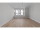 Bright dining room featuring modern chandelier, light wood floors, and natural light through the large windows at 811 Maple Berry Ln # 102, Raleigh, NC 27607