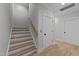 Elegant staircase with light wood treads and white risers, complemented by a matching handrail and light wood floors at 811 Maple Berry Ln # 102, Raleigh, NC 27607