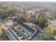 Aerial view of a multi-unit residential complex surrounded by lush greenery and a mix of residential and commercial areas at 811 Maple Berry Ln # 103, Raleigh, NC 27607