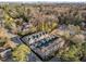 Aerial view of a residential complex showcasing modern townhouses with well-manicured landscaping and nearby city skyline at 811 Maple Berry Ln # 103, Raleigh, NC 27607