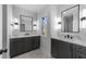 A bathroom with a double vanity, modern light fixtures, and a large window to allow natural light at 811 Maple Berry Ln # 103, Raleigh, NC 27607