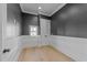 Charming bedroom featuring stylish wainscoting and hardwood floors at 811 Maple Berry Ln # 103, Raleigh, NC 27607