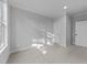 Bedroom has carpet, white trim, and a window for natural light, providing a cozy and comfortable living space at 811 Maple Berry Ln # 103, Raleigh, NC 27607