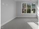 Neutral bedroom features a large window that allows natural light to brighten the room, complete with carpeted floors at 811 Maple Berry Ln # 103, Raleigh, NC 27607