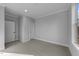 Bright bedroom features a large window, neutral walls and carpets, along with doors and trim painted in white at 811 Maple Berry Ln # 103, Raleigh, NC 27607