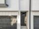 Modern home exterior featuring a gray front door, two-car garage, and a contrasting white facade at 811 Maple Berry Ln # 103, Raleigh, NC 27607