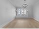 Bright living room with a large window and hardwood floors at 811 Maple Berry Ln # 103, Raleigh, NC 27607