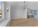 Open-concept living area with a modern chandelier and hardwood floors at 811 Maple Berry Ln # 103, Raleigh, NC 27607