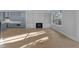 Bright living room featuring hardwood floors, a fireplace, and built-in shelving surrounding the fireplace at 811 Maple Berry Ln # 103, Raleigh, NC 27607