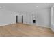 A large bedroom includes multiple doors, hard wood floors, recessed lighting, and windows for natural light at 811 Maple Berry Ln # 103, Raleigh, NC 27607