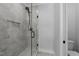 A stunning walk-in shower features gray tile, a glass door, and a rain shower head at 811 Maple Berry Ln # 103, Raleigh, NC 27607